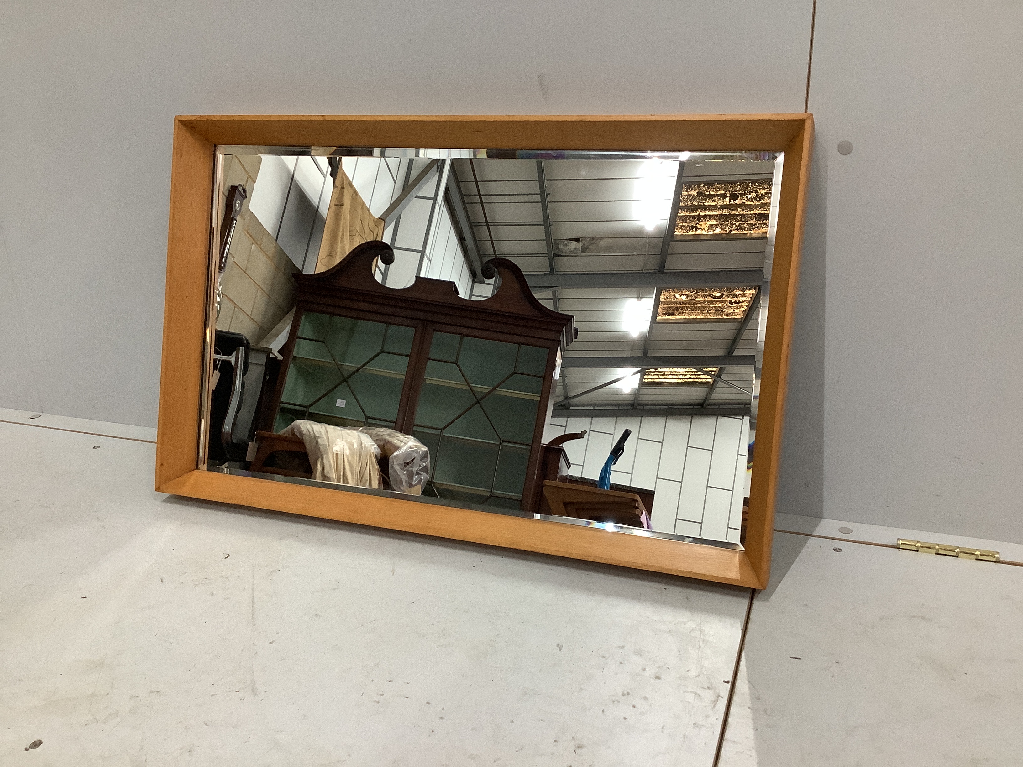 A mid century rectangular teak wall mirror, retailed by Heals, width 80cm, height 50cm